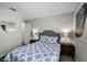 Comfortable bedroom with an upholstered headboard, stylish lamps, and matching end tables on each side of the bed at 339 Holborn Loop, Davenport, FL 33897