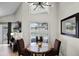 Dining area with a modern light fixture, a window view of the pool, and neutral wall colors at 339 Holborn Loop, Davenport, FL 33897