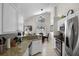 Bright kitchen with stainless steel appliances, granite counters, and views into the dining and living areas at 339 Holborn Loop, Davenport, FL 33897