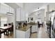 Open kitchen view highlighting granite countertops, stainless appliances, and a dining area with modern lighting at 339 Holborn Loop, Davenport, FL 33897