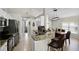 Kitchen featuring a breakfast bar with granite countertops and stainless steel appliances, adjacent to the dining area at 339 Holborn Loop, Davenport, FL 33897