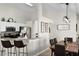 Well-lit kitchen area with granite countertops, stainless steel appliances, and an adjacent dining space at 339 Holborn Loop, Davenport, FL 33897