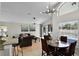 Bright living room featuring vaulted ceilings, contemporary lighting, and a view of the pool area at 339 Holborn Loop, Davenport, FL 33897