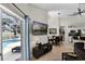 Open concept living space with dining and living room and outdoor view of pool at 339 Holborn Loop, Davenport, FL 33897