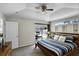 Bright main bedroom with a vaulted ceiling, a modern ceiling fan, and sliding glass doors for pool access at 339 Holborn Loop, Davenport, FL 33897