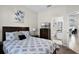 Comfortable main bedroom featuring a decorative painting, television, closet, and an ensuite bathroom at 339 Holborn Loop, Davenport, FL 33897