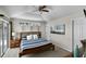 Inviting main bedroom featuring a modern ceiling fan, a comfy bed with a pool view through the sliding glass doors at 339 Holborn Loop, Davenport, FL 33897