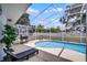 Screened-in pool area featuring patio furniture, grill, and covered outdoor space at 339 Holborn Loop, Davenport, FL 33897