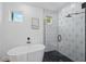 Modern bathroom featuring a soaking tub and glass shower with geometric tilework at 3650 Grant Blvd, Orlando, FL 32804