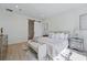 Modern bedroom with neutral color scheme, minimalist decor, and a sliding barn door at 3650 Grant Blvd, Orlando, FL 32804