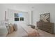 Bright bedroom with a wooden accent dresser, neutral bedding, and a view from the window at 3650 Grant Blvd, Orlando, FL 32804