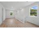 Upstairs hallway with new wood flooring and large windows, allowing for natural light to pour through at 3650 Grant Blvd, Orlando, FL 32804