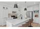 Modern white kitchen with quartz countertops, stainless steel appliances, and pendant lighting at 3650 Grant Blvd, Orlando, FL 32804