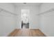 Spacious walk-in closet with hardwood floors, custom wire shelving, and a view into the bathroom at 3650 Grant Blvd, Orlando, FL 32804