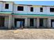 Unfinished townhouse exteriors showing the beginning stages of construction with open window and door frames at 4252 Campsite Loop, Orlando, FL 32824