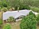 Aerial view of a well-maintained house showcasing a new roof, green landscaping, and mature trees for added appeal at 4802 Anton Ave, Apopka, FL 32712