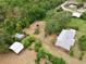 Aerial view of home with outbuildings, showcasing the property layout, mature landscaping, and fenced perimeter at 4802 Anton Ave, Apopka, FL 32712