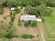 An aerial shot showcases a home with mature trees and a fenced perimeter, providing a sense of privacy and security at 4802 Anton Ave, Apopka, FL 32712