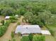 Aerial view of property with lush tree coverage showcasing the home's location, and lot size, perfect for privacy at 4802 Anton Ave, Apopka, FL 32712