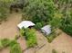 Aerial view of property showcasing two outbuildings, perfect for a workshop or storage, and a fenced perimeter at 4802 Anton Ave, Apopka, FL 32712