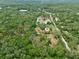 Distant aerial shot of the property featuring the main house with additional storage structures on the lot at 4802 Anton Ave, Apopka, FL 32712