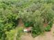 Aerial view showcasing a wooded property, featuring a small storage building at 4802 Anton Ave, Apopka, FL 32712