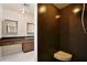 Bathroom view showcases dark granite shower and vanity with dual mirrors, offering a blend of style and function at 4802 Anton Ave, Apopka, FL 32712