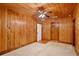 Bedroom featuring paneled walls, tile flooring, and a ceiling fan at 4802 Anton Ave, Apopka, FL 32712