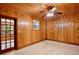 Bedroom featuring paneled walls and access to the lanai at 4802 Anton Ave, Apopka, FL 32712