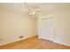 Bedroom with hardwood floors, a ceiling fan, and a closet offering ample storage space, providing comfort and convenience at 4802 Anton Ave, Apopka, FL 32712