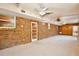 Bonus room showcasing a brick wall, carpeting and a ceiling fan at 4802 Anton Ave, Apopka, FL 32712