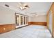 Spacious bonus room with a tile floor, French doors, and wood paneled walls at 4802 Anton Ave, Apopka, FL 32712