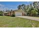 Spacious home with attached garage, complemented by a well-manicured lawn and a paved driveway at 4802 Anton Ave, Apopka, FL 32712