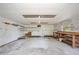 Spacious garage featuring built-in shelving, a work bench, and pegboard walls, ideal for storage and projects at 4802 Anton Ave, Apopka, FL 32712
