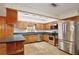 Classic kitchen featuring wood cabinetry, stainless steel appliances, and ample counter space at 4802 Anton Ave, Apopka, FL 32712