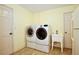 Bright laundry room featuring a front-load washer and dryer with a utility sink for added convenience at 4802 Anton Ave, Apopka, FL 32712