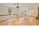 Bright living room with a modern light fixture, hardwood floors, and large windows at 4802 Anton Ave, Apopka, FL 32712