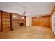 Living room with a brick fireplace, built-in shelving and wood paneled walls at 4802 Anton Ave, Apopka, FL 32712