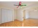 Spacious living room featuring bright hardwood floors and a whimsical, multi-colored ceiling fan for a unique touch at 4802 Anton Ave, Apopka, FL 32712