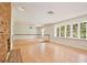 Spacious living room with hardwood floors, large windows, and a brick fireplace at 4802 Anton Ave, Apopka, FL 32712