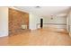 Bright living room featuring a brick fireplace, laminate floors, and an open floor plan at 4802 Anton Ave, Apopka, FL 32712