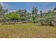 Outdoor shot of a grassy yard with a storage shed behind a wooden fence at 4802 Anton Ave, Apopka, FL 32712