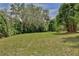 Sprawling green backyard featuring mature trees and plenty of open space for outdoor activities and recreation at 4802 Anton Ave, Apopka, FL 32712