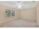 Bright bedroom with a ceiling fan and a large window providing natural light at 4952 Tangerine Ave # 4952, Winter Park, FL 32792