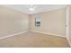 Carpeted bedroom with ceiling fan and window overlooking the yard at 4952 Tangerine Ave # 4952, Winter Park, FL 32792