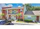 A brightly colored townhome is shown with a well-manicured lawn at 4952 Tangerine Ave # 4952, Winter Park, FL 32792