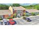 View of the building shows colorful townhomes and a parking area at 4952 Tangerine Ave # 4952, Winter Park, FL 32792