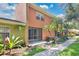 Exterior view of the building from the back featuring palm trees and lush landscaping at 4952 Tangerine Ave # 4952, Winter Park, FL 32792
