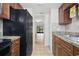 Galley kitchen with stone countertops and black appliances leading to the outdoors through sliding glass doors at 4952 Tangerine Ave # 4952, Winter Park, FL 32792
