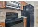 Kitchen has black appliances, granite counters and wooden cabinetry at 4952 Tangerine Ave # 4952, Winter Park, FL 32792